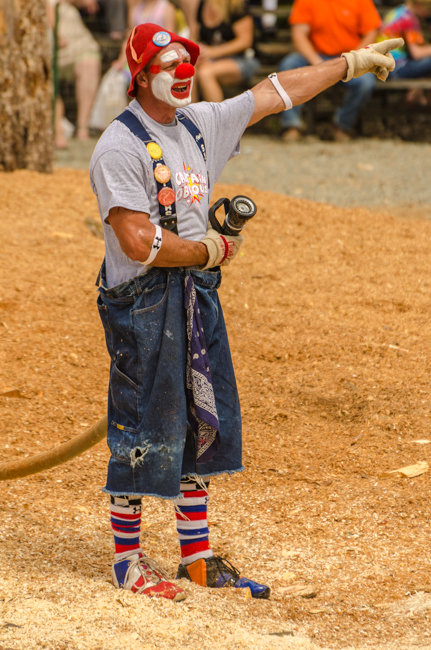 The clown is preparing to cool off the crowd.