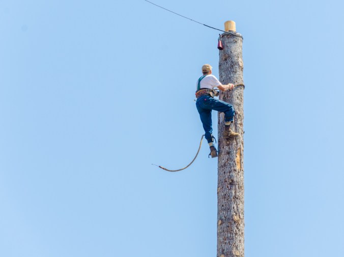 In this competition, people had to climb this large pole and then ring the bell at the top.