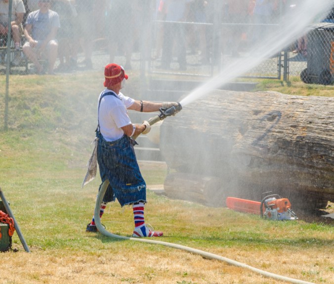 Because it was hot, everyone loved it when the clown provided air conditioning by spraying them with water.