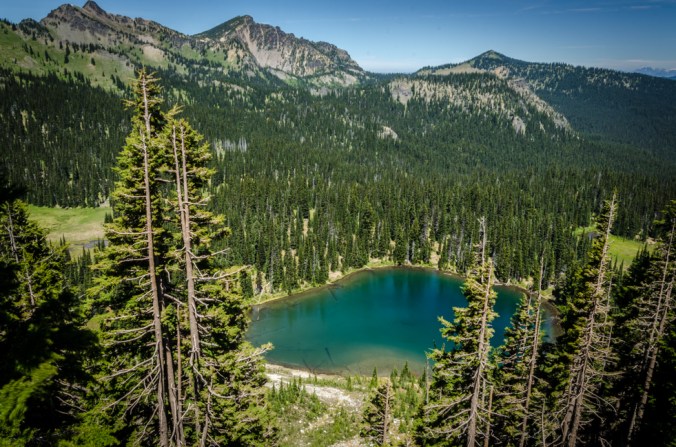 A lake can be seen near the top of the mountain.